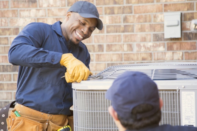 5 Air Conditioning Fun Facts. HVAC technicians working on outdoor unit.