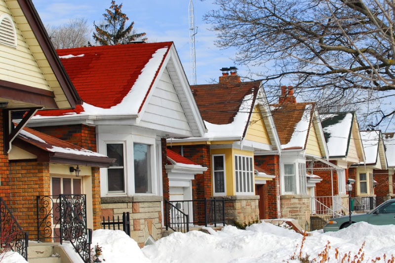 Row of residential houses in winter with snow.