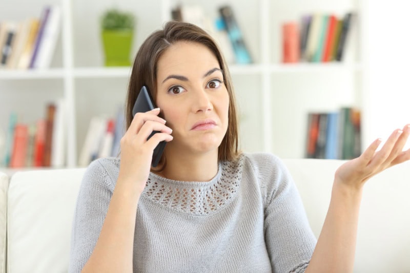 Common Sewer Odors in Your Home: What’s That Smell? Women on phone.