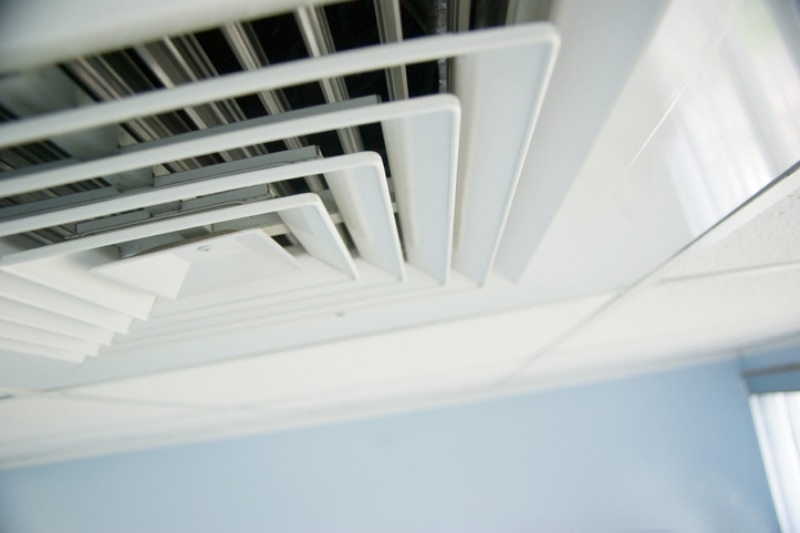 How Often Should I Clean My Air Ducts? Air condition vent in office ceiling close up.