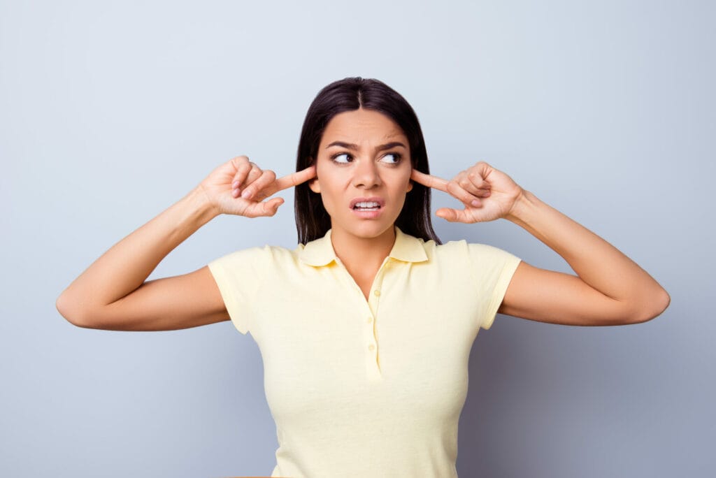 woman with fingers in ears