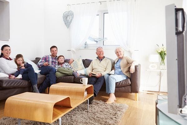 Image of family sitting together. Conventional HVAC or a Heat Pump: Which Is Better?