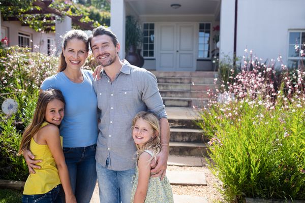 Image of family posing for photo outside of home. Improve Your Indoor Air With a Ventilator.